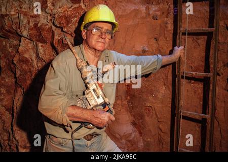 Grahame McMahon, pensionato il clergyman anglicano ora opale minatore sotterraneo nella sua miniera a Lightning Ridge Foto Stock