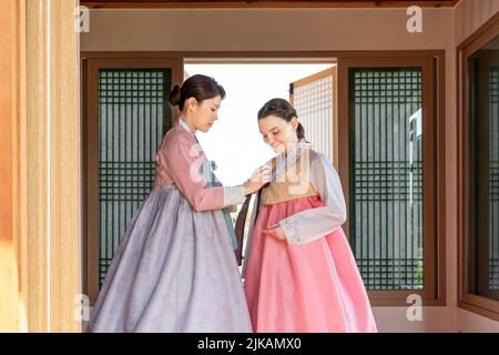 Ragazze coreane e caucasiche che indossano abiti tradizionali coreani Hanbok Foto Stock