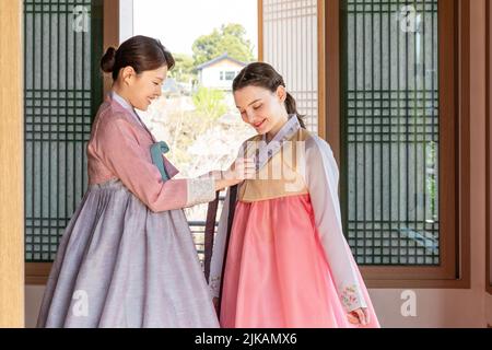 Ragazze coreane e caucasiche che indossano abiti tradizionali coreani Hanbok Foto Stock