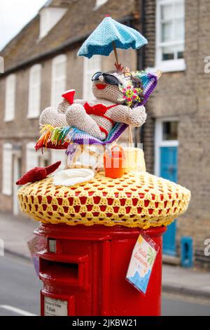 Una decorazione a maglia sulla parte superiore di una casella postale a Ely, Cambridgeshire accogliente in estate. Foto Stock