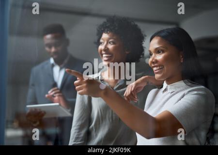 Le cose stanno funzionando bene. Tre uomini d'affari che lavorano in un ufficio moderno. Foto Stock