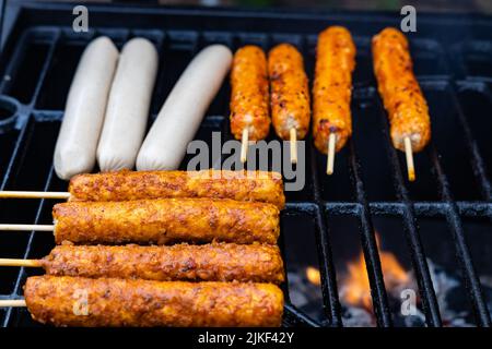 salsicce vegane e spiedini vegani su una griglia a carbone Foto Stock