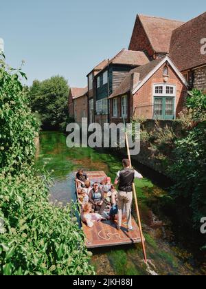 I turisti d'estate visitiors che enoying un giro in barca del punt lungo il fiume Stour attraverso il centro del vecchio Canterbury Kent Inghilterra UK - turismo che punta l'estate Foto Stock