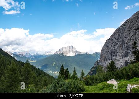 uno scatto panoramico della valle di montagna contro la grande montagna coperta di neve Foto Stock