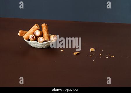 Lo Studio shot di un piatto con cialde di crema su un tavolo Foto Stock