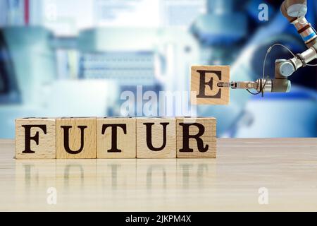 Robot di presa industriale che raccoglie la lettera di legno per messaggio di costruzione su scrivania di legno e macchina colore blu su sfondo sfocato Foto Stock