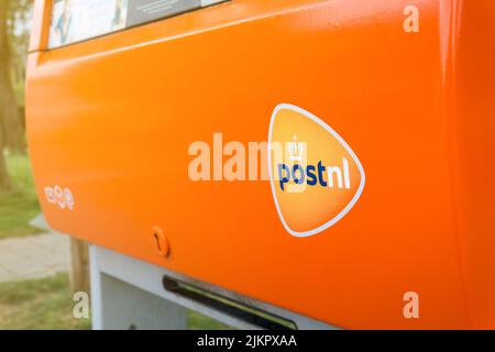 Casella postale PostNL arancione con logo in primo piano. Casella postale della società di servizi postali olandese. Hertogenbosch, Paesi Bassi - 7 maggio 2022. Foto Stock