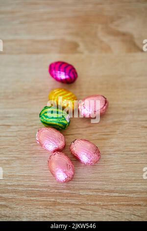 Piccole uova di cioccolato pasquale confezionate in fogli colorati Foto Stock