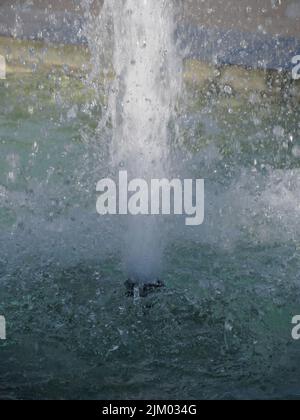 Schizzi di fontana di acqua in una giornata di sole Foto Stock
