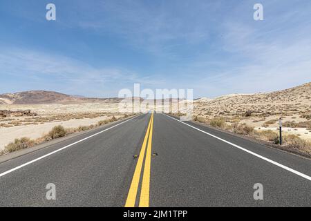 Strada nel mezzo del nulla passando il deserto negli Stati Uniti Foto Stock