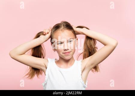 gioiosa ragazza maialino code stile di vita dei capelli adolescente Foto Stock