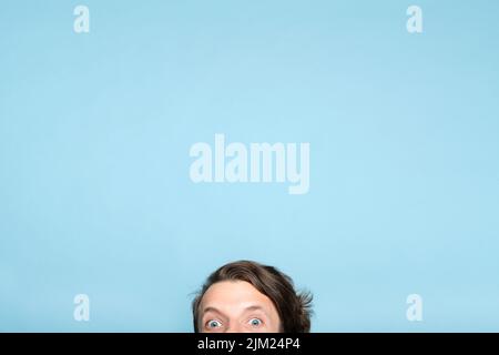un uomo eccentrico stellato sorridendo gli occhi che sbucciano verso il basso Foto Stock