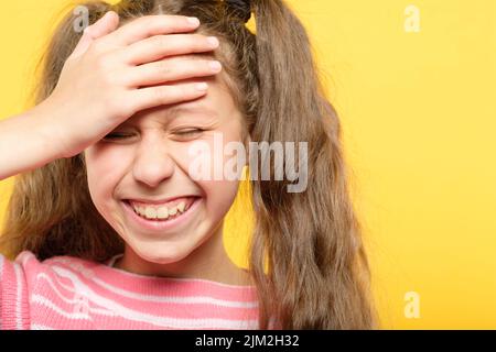 ridendo imbarazzato ragazza coprire fronte facepalm Foto Stock