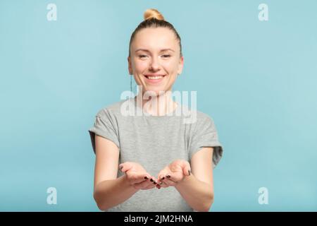 donna sorridente che tiene palme vuote oggetto virtuale Foto Stock