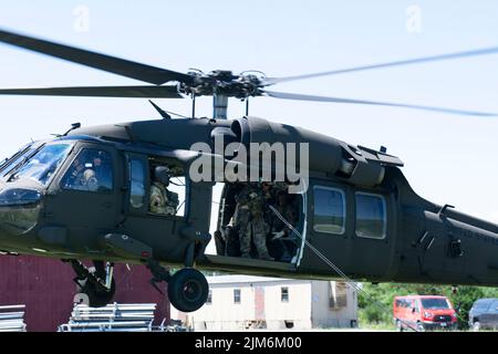 Il maestro del rapel con la sede centrale e la sede centrale della compagnia, 1st Battaglione, 110th reggimento fanteria, 2nd squadra di combattimento di brigata fanteria, dirige i soldati sotto il falco nero UH-60 durante l'addestramento del rappello a Fort Indiantown Gap, Pa., il 3 agosto 2022. I soldati del 1-110th hanno lavorato con i piloti e gli equipaggi del 28th Expeditionary Combat Aviation Brigade per rapel dal falco nero (foto dell'esercito degli Stati Uniti di Sgt. 1st Classe Matthew Keeler) Foto Stock