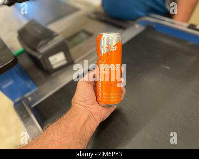 Grovetown, GA USA - 05 03 22: Negozio al dettaglio bevande tenere la mano Red Bull al registro edizione estiva Foto Stock