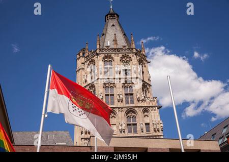 La bandiera di Colonia di fronte alla torre del municipio storico nella parte vecchia della città, Colonia, Germania. Die Koelner Flagge vor dem Turm d Foto Stock