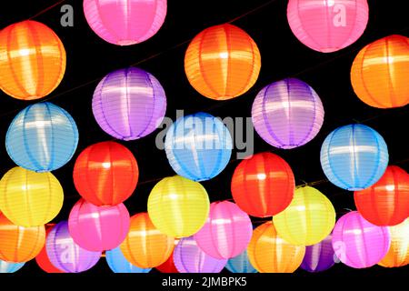 Lampada tradizionale cinese colorata Lanterna su sfondo scuro. Sfondo di lanterne multicolore. Foto Stock