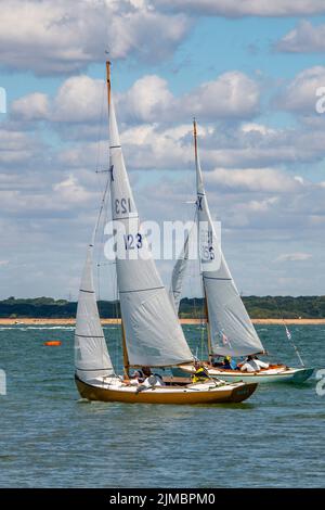 barche e gommoni che corrono al largo della costa dell'isola di wight durante la regata annuale di vela della settimana di cowes, flotta di yacht a vela che racing settimana di cowes. Foto Stock