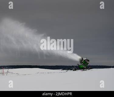 Macchina per la neve sulle piste da sci in inverno. Polvere di neve spruzzata. Foto Stock