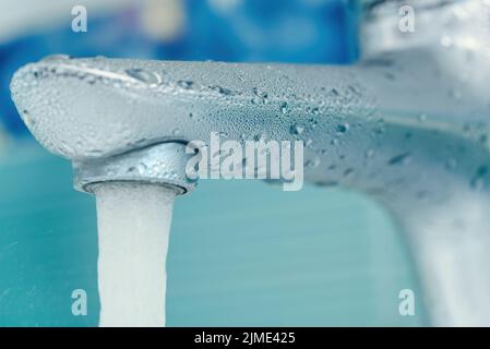 Gocce d'acqua sul rubinetto in bagno. Foto macro Foto Stock