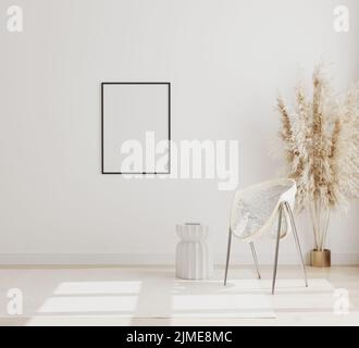 Cornice verticale vuota mock up su parete bianca in moderno sfondo interno con sedia e pampas erba su pavimento in legno, scandinavi Foto Stock