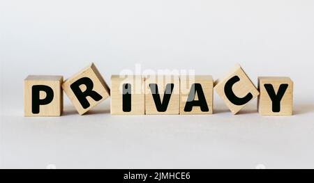 Parola PRIVACY scritto su blocco di legno e sfondo bianco Foto Stock
