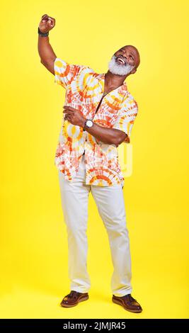 Ive ha ancora tutte le mosse. Ripresa a tutta lunghezza di un uomo anziano funky ed elegante che balla in studio su sfondo giallo. Foto Stock