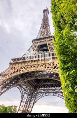 Vista dal basso della Torre Eiffel con il tempo nuvoloso Foto Stock