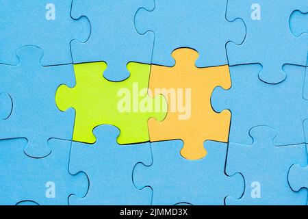 I pezzi di puzzle verdi e gialli si distingue dalla folla Foto Stock