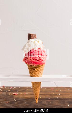 Misurino di ghiaccio congelato rosso con cono di cioccolato panna montata Foto Stock