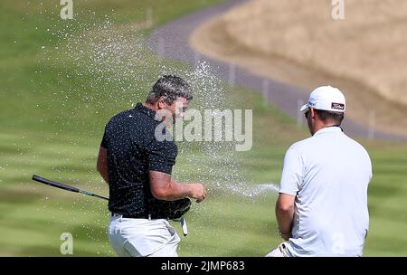 Il Callum Shinkwin dell'Inghilterra viene spruzzato con Champagne sul verde 18th dopo aver vinto il Cazoo Welsh Open durante il giorno quattro del Cazoo Wales Open al Celtic Manor Resort di Newport, Galles. Data foto: Domenica 7 agosto 2022. Foto Stock