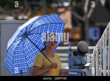 Fuyang, Cina. 07th ago 2022. Una donna ha visto tenere un ombrello durante il tempo caldo. Secondo le previsioni dell'Osservatorio Meteorologico Centrale della Cina, nei prossimi 10 giorni, le alte temperature continueranno in alcune parti della Cina, con la temperatura massima che raggiunge i 37-39 ° C e la temperatura locale di 40 ° C o superiore. Credit: SOPA Images Limited/Alamy Live News Foto Stock