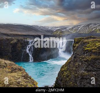 Pittoresca cascata Sigoldufoss vista autunno. Stagione che cambia nelle Highlands meridionali dell'Islanda. Foto Stock