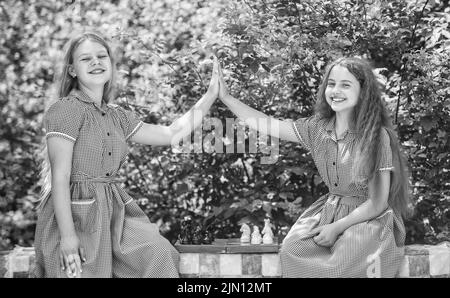 due ragazze teen che giocano a scacchi. sviluppo d'infanzia. amicizia e sisterhood. Foto Stock