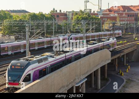 Treno locale che si avvicina alla stazione ferroviaria di Pasila a Helsinki, Finlandia Foto Stock