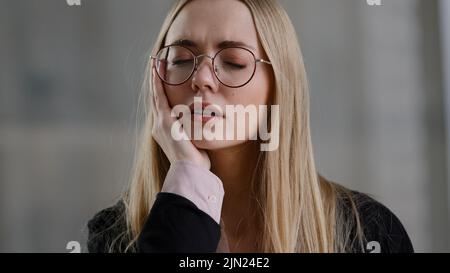 Stanco malato business donna ragazza che tiene testa mal di testa febbre sente mal di denti dolore malessere dolore soffre di febbre affaticamento mal di pressione massaggi Foto Stock