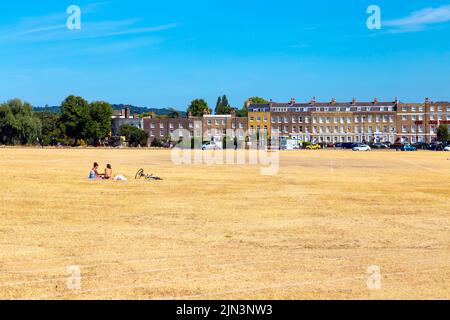 6 Agosto 2022 - Londra, UK - la gente picnicing su asciutto prateria fuori a Blackheath dopo una serie di onde di calore e record di alte temperature in città Foto Stock