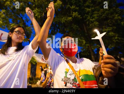 Chiang mai, Thailandia, 08/08/2022, un attivista tiene una candela illuminata e fa un saluto a tre dita durante l'anniversario della '8888 rivolta' alla porta di Tha Phae a Chiang mai. Il 8th agosto Myanmar ha commemorato il 34th anniversario della "rivolta del 8888", nota anche come rivolta del potere popolare, Che ha raggiunto il picco il 08 agosto 1988, è stata una serie di manifestazioni, marce e proteste a livello nazionale che hanno iniziato come movimento studentesco a Yangon prima di diffondersi nel resto del paese. Le manifestazioni sono state tenute contro il regime del Partito del programma socialista birmano (BSPP), allora al potere, una stat monopartitica Foto Stock