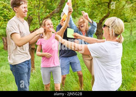 I giovani si divertono con carte colorate in un laboratorio creativo di team building Foto Stock