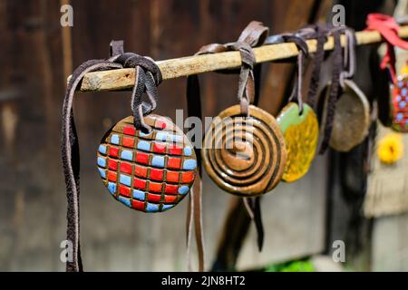 Gruppo di collane colorate dipinte a mano e di souvenir esposti in vendita in un tradizionale mercato del fine settimana a Bucarest, Romania Foto Stock