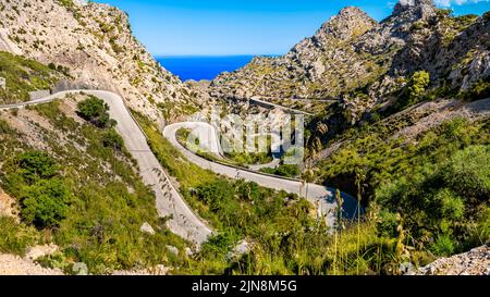 Mallorca tortuosa strada ma-2141 che conduce attraverso terreni estremi in una valle di Serra de Tramuntana montagne, curvando in stretta serpentina giù. Foto Stock