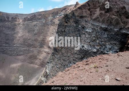 Primi piani intorno al cono in cima al Vesuvio Italia che mostra i diversi strati di roccia rivolti verso la bocca chiusa. Foto Stock