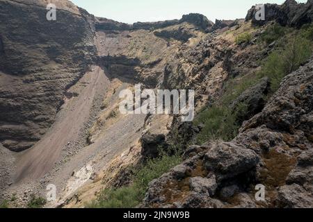 Primi piani intorno al cono in cima al Vesuvio Italia che mostra i diversi strati di roccia rivolti verso la bocca chiusa. Foto Stock