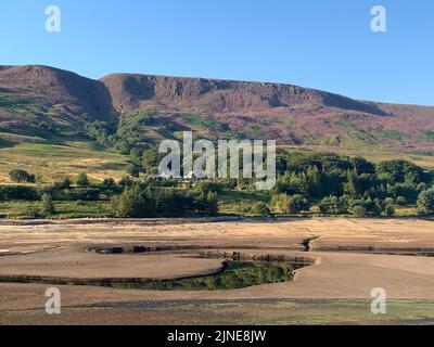 Una vista dei bassi livelli dell'acqua presso la United Utilities, Woodhead Reservoir, nel Derbyshire. L'ufficio MET ha emesso un avvertimento di calore color ambra in corso tra giovedì e domenica, che potrebbe vedere picchi di temperatura a 36C °C nell'Inghilterra meridionale e nel Galles orientale, con alcune aree che devono affrontare un rischio 'eccezionale' di incendi boschivi mentre l'indice di gravità degli incendi viene portato al livello più alto. Data immagine: Giovedì 11 agosto 2022. Foto Stock