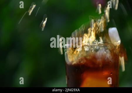 bicchieri di succo di albicocca su tavolo di legno su fondo verde. albicocche appena raccolte in giardino su un vecchio tavolo di legno. albicocche fresche su un legno Foto Stock