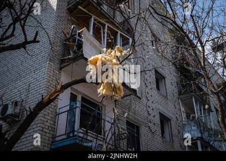 Un materiale da costruzione di parete saltato in su visto appeso all'albero dopo uno sciopero missilistico russo in Slovyansk. In mezzo ai combattimenti intensificati nella parte orientale dell'Ucraina, milioni di famiglie ucraine sono state evacuate dalla guerra più vicina e più stretta, in quanto molte di esse saranno delocalizzate nella parte occidentale del paese. Slovyansk con una popolazione di 106.972 abitanti (2021 est.), oggi è una città strategica principale nella regione di Donetsk di Donbas, poiché la città è stata continuamente pesantemente bombardata da artiglieri e missili russi, dall'inizio della guerra, oltre il 80% dei civili hanno già evacuato Foto Stock