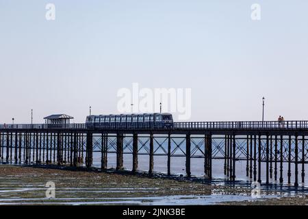 Molo di Southend Pleasure con bassa marea e treno in una giornata di sole con cielo blu e luminoso durante l'ondata di caldo estiva nel Regno Unito Foto Stock