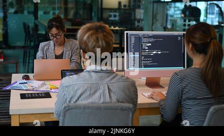 Il team di programmazione lavora e si riunisce in un ufficio moderno Foto Stock