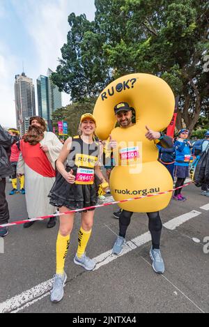 Sydney, Australia.14 Agosto 2022: Circa 60.000+ persone partecipano alla gara del 50th City2Surf a Sydney, la prima dal 2019 dopo le cancellazioni nel 2020 e nel 2021 a causa delle restrizioni del Covid-19. La corsa di quattordici chilometri, la più grande del suo genere al mondo, conduce i corridori da Hyde Park fuori dalla città, su e sopra la collina heartbreak e sopra a Bondi Beach. Nella foto: Non tutti sono lì per rompere un disco, molte persone corrono per beneficenza o solo per divertimento. Credit: Stephen Dwyer / Alamy Live News Foto Stock